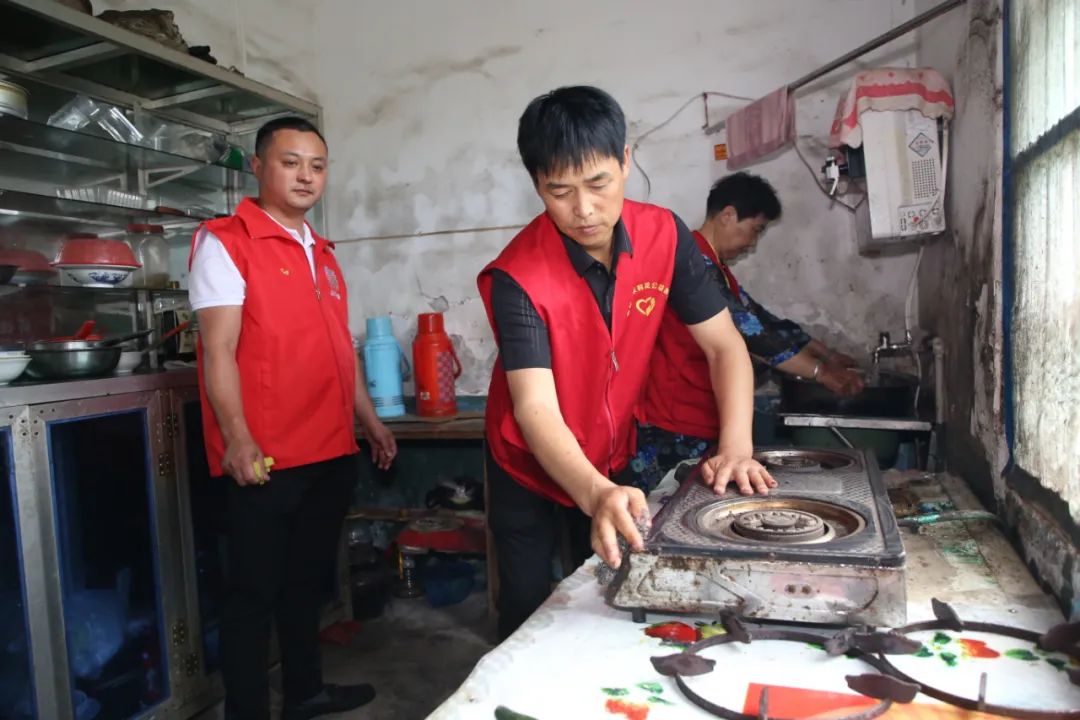 志愿者李大勇等为社区居民修理煤气灶.jpg